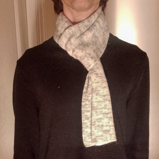 100% Peruvian Baby alpaca scarf in natural white with light blue dots on a model.