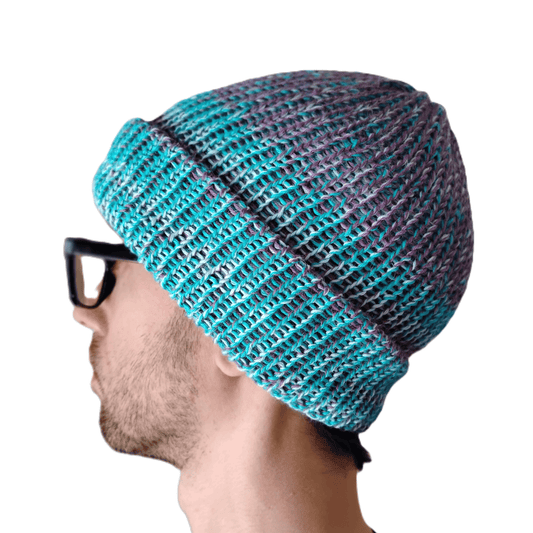 A variegated blue baby alpaca beanie on a model