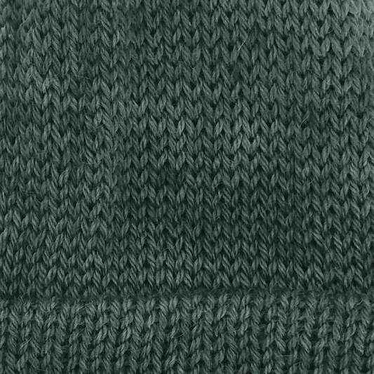 Close-up of a dark green knit alpaca in worsted weight.