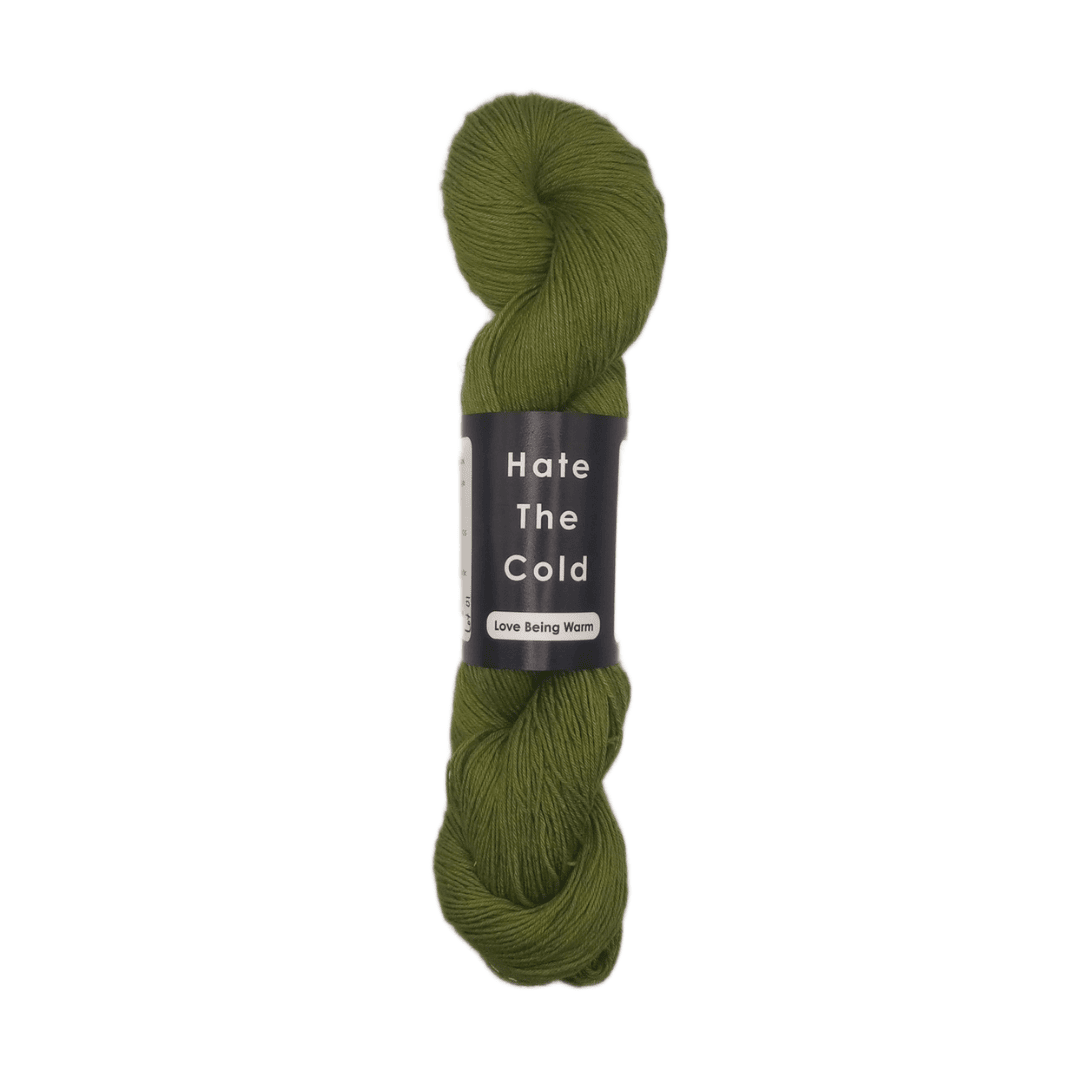 Green skein of yarn with a label on a white background
