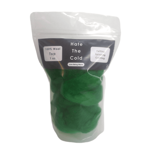 Green wool top in a package with "Hate The Cold" on the label