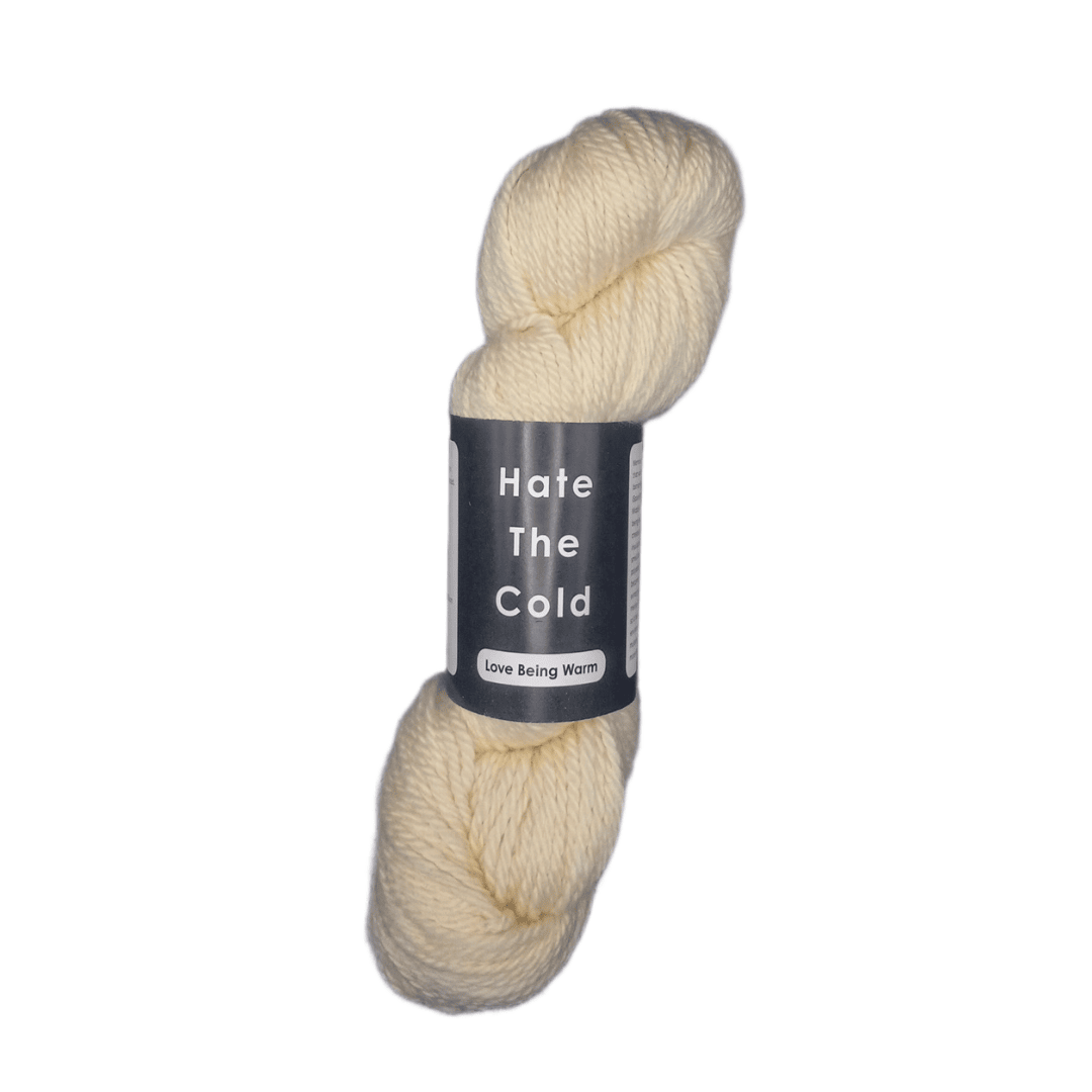 Cream-colored skein of yarn with a label on a white background