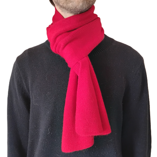 A red knit scarf against a plain white background.