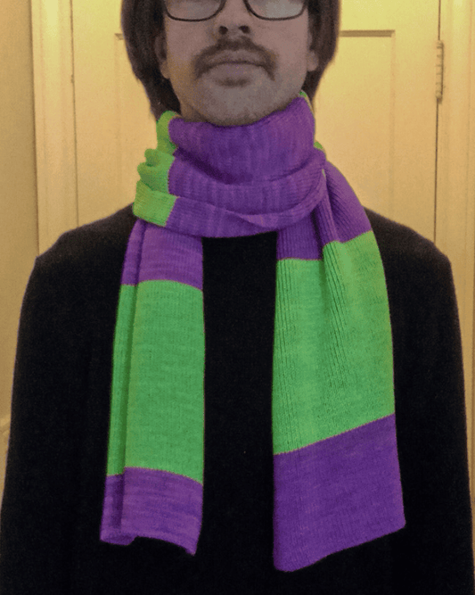 Person wearing a purple and green striped scarf.