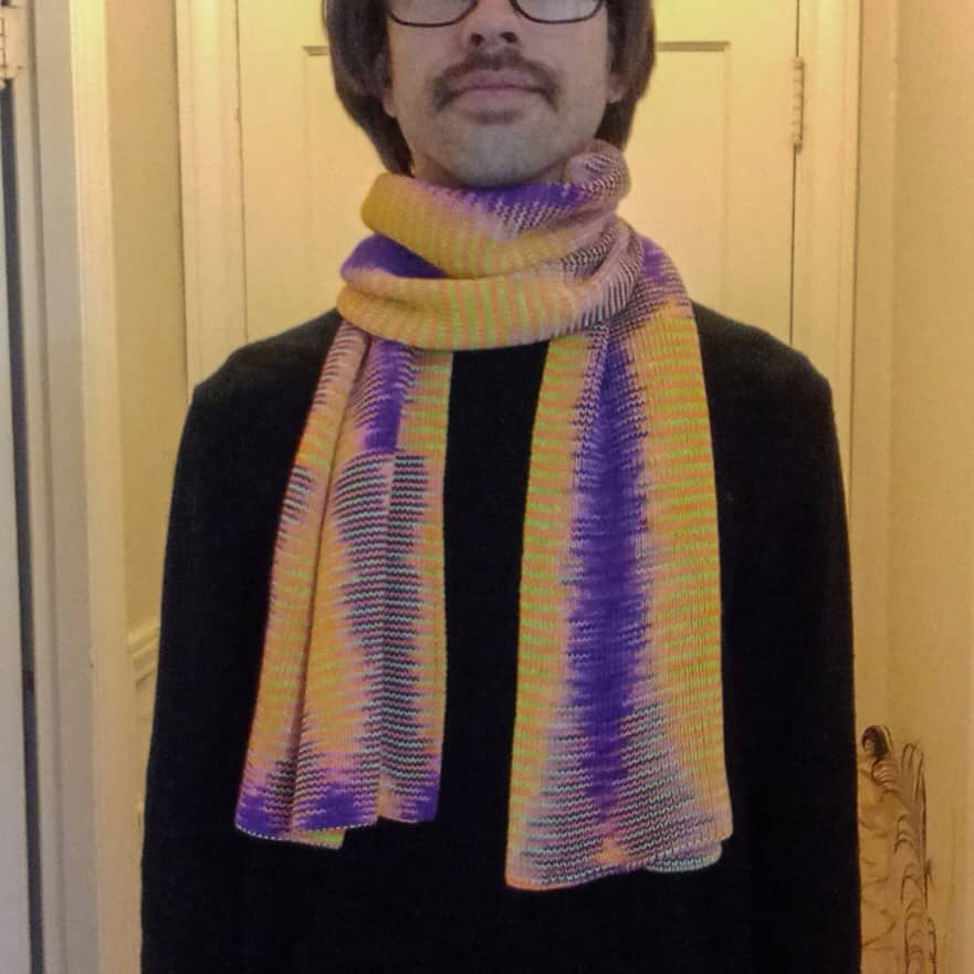 100% merino wool scarf in yellow and purple on a model