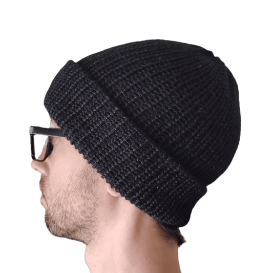 A black baby alpaca beanie on a model