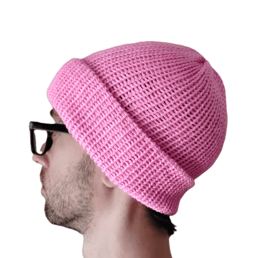 A pink baby alpaca beanie on a model