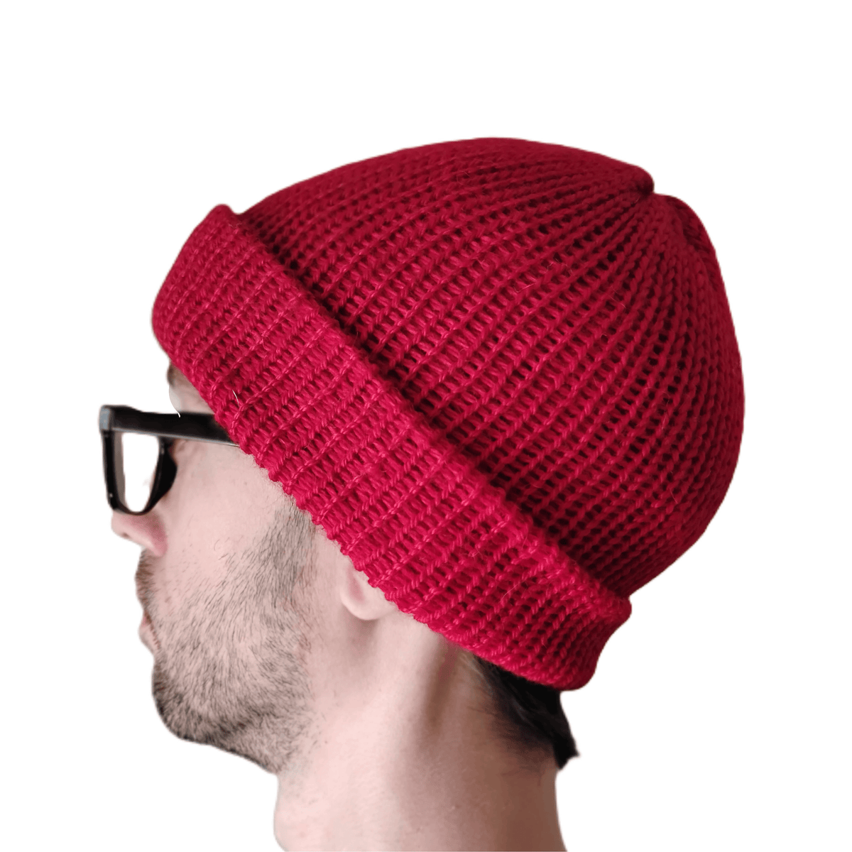 A red baby alpaca beanie on a model