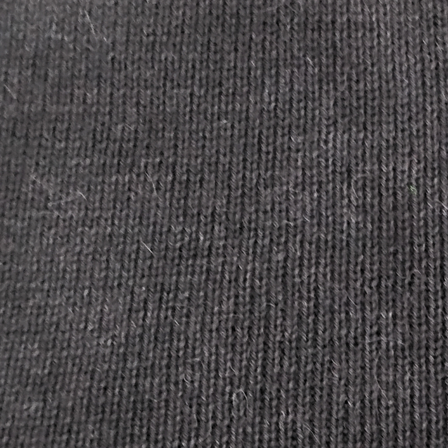 Close-up of dark charcoal knit alpaca.
