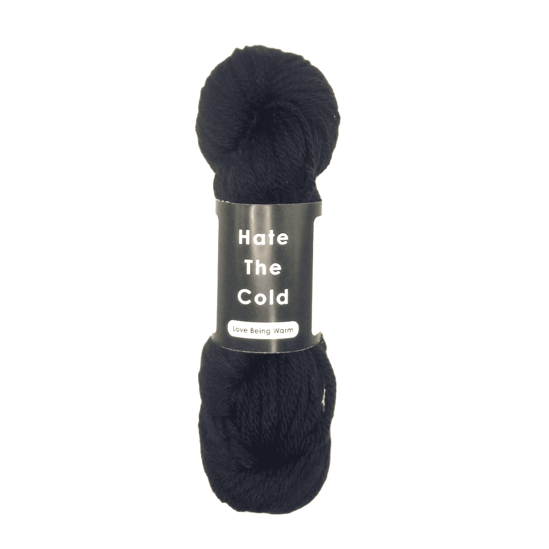 Black merino wool yarn skein in aran weight with 'Hate The Cold' label on a white background