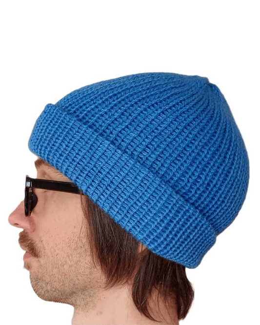 100% baby alpaca beanie in blue on a model