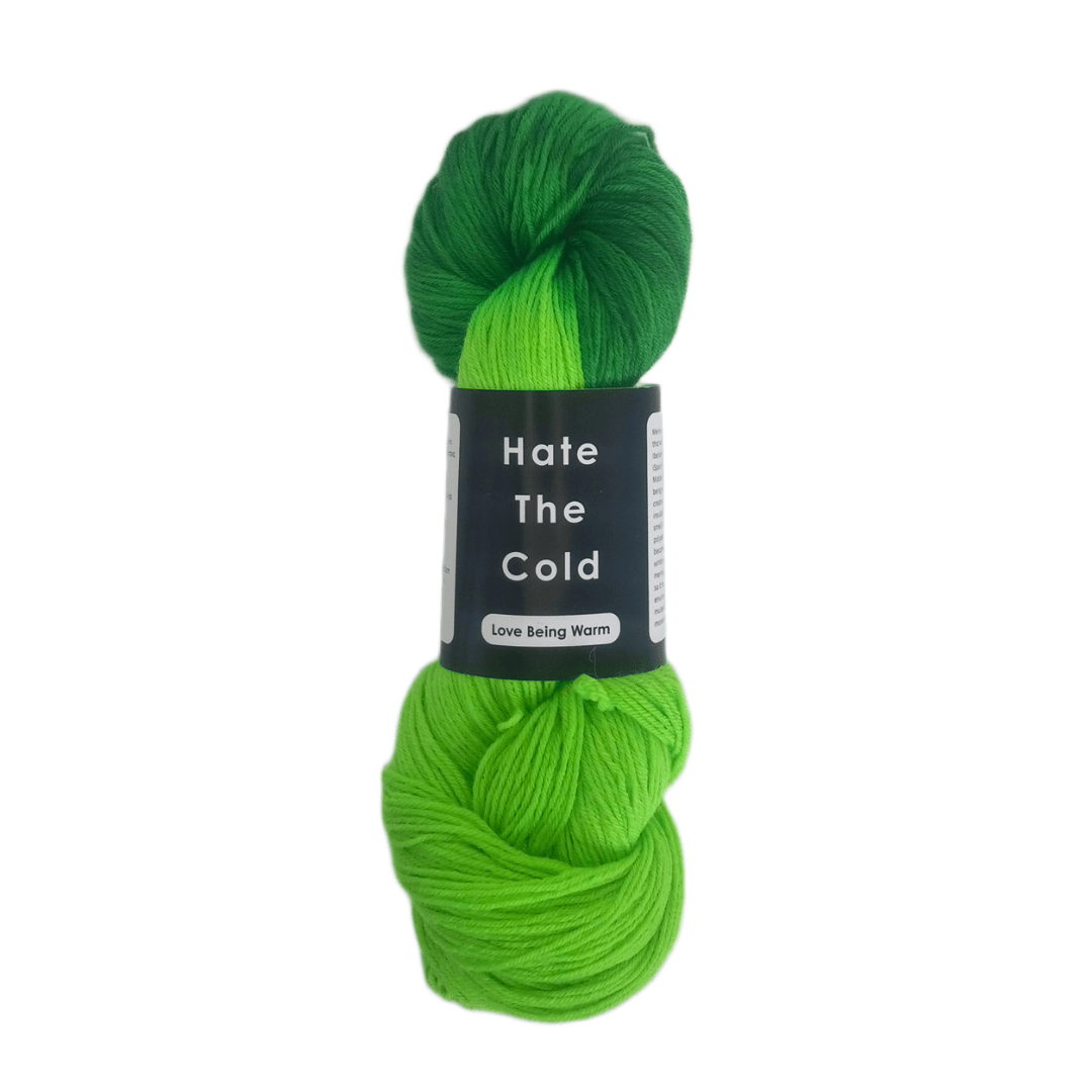 Hand-dyed merino wool yarn in fingering weight with variegated shades of green