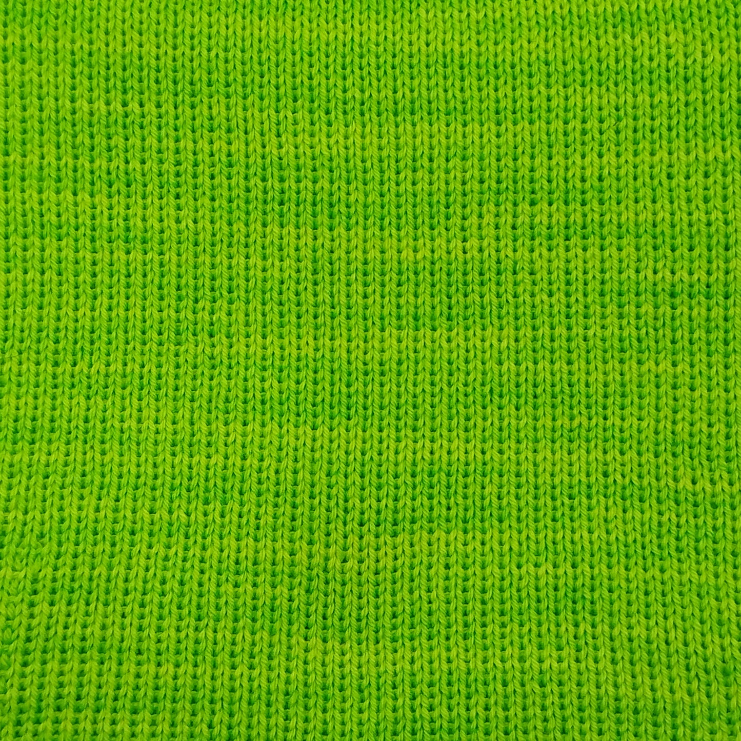 A close-up of fluorescent green knit merino wool in fingering weight.
