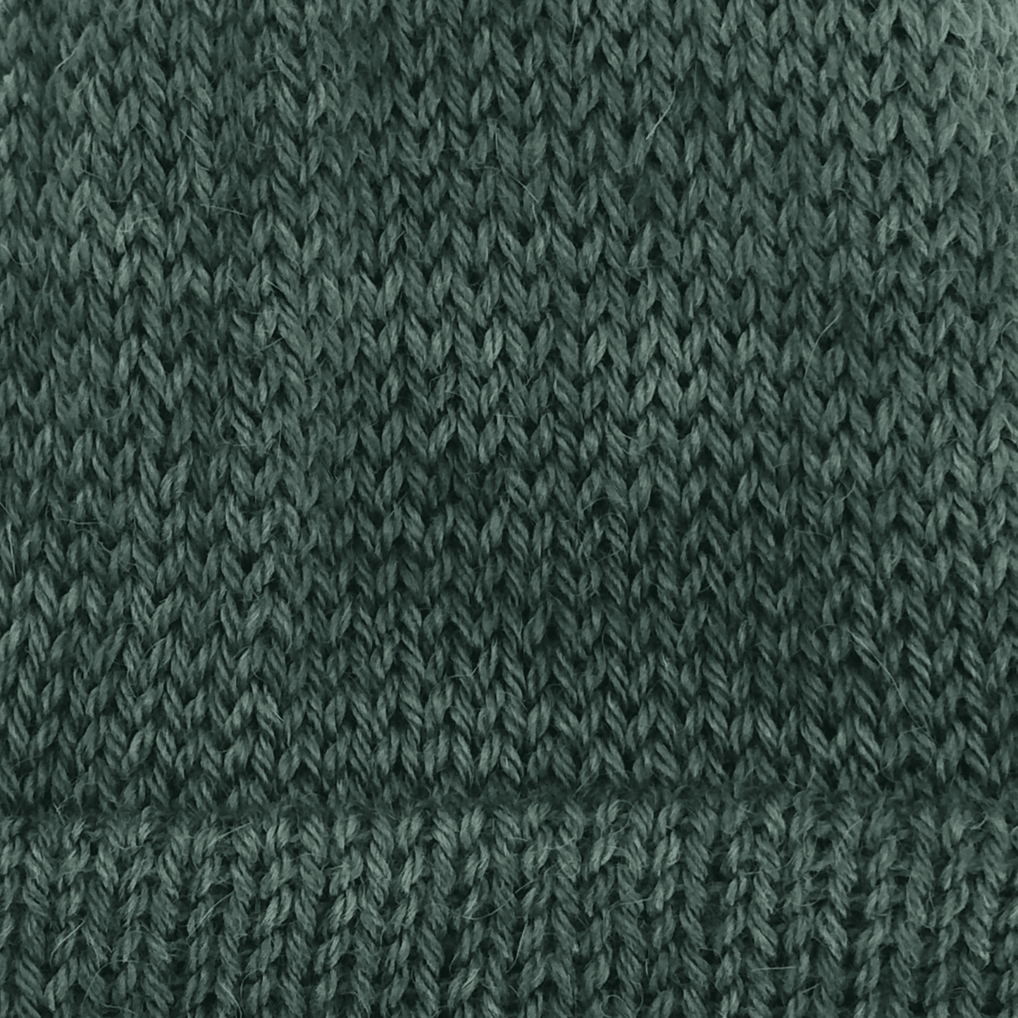 Close-up of a dark green knit alpaca in worsted weight.