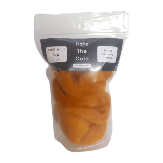 Gold wool top in a package with "Hate The Cold" on the label