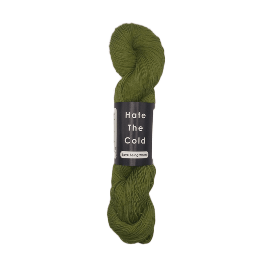 Green skein of yarn with a label on a white background
