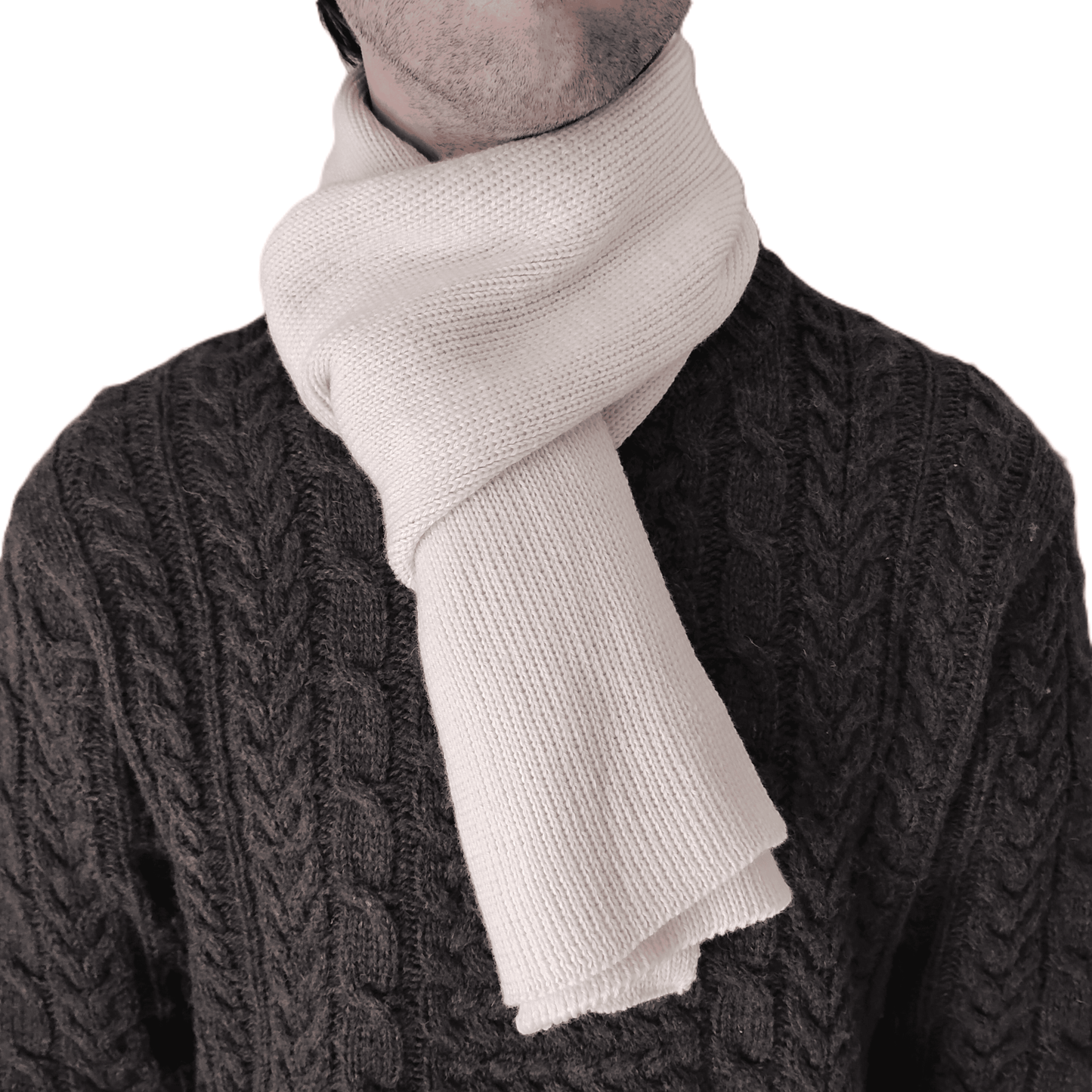 A close-up of a person wearing a thick, cream-colored knit merino wool scarf.