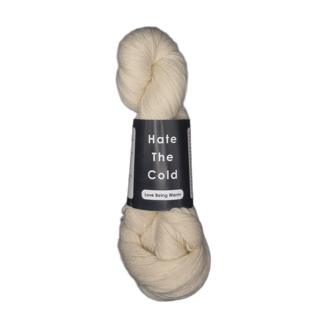 Natural merino yarn skein with 'Hate The Cold' label on a white background