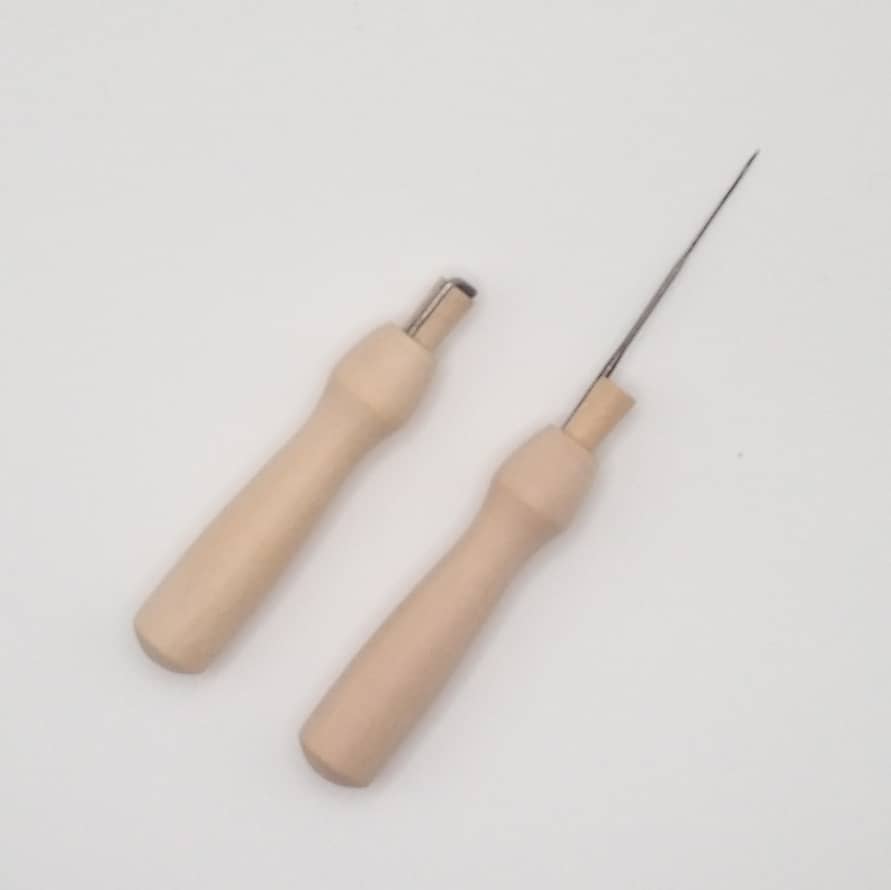 One open needle felting needle next to a closed needle felting needle