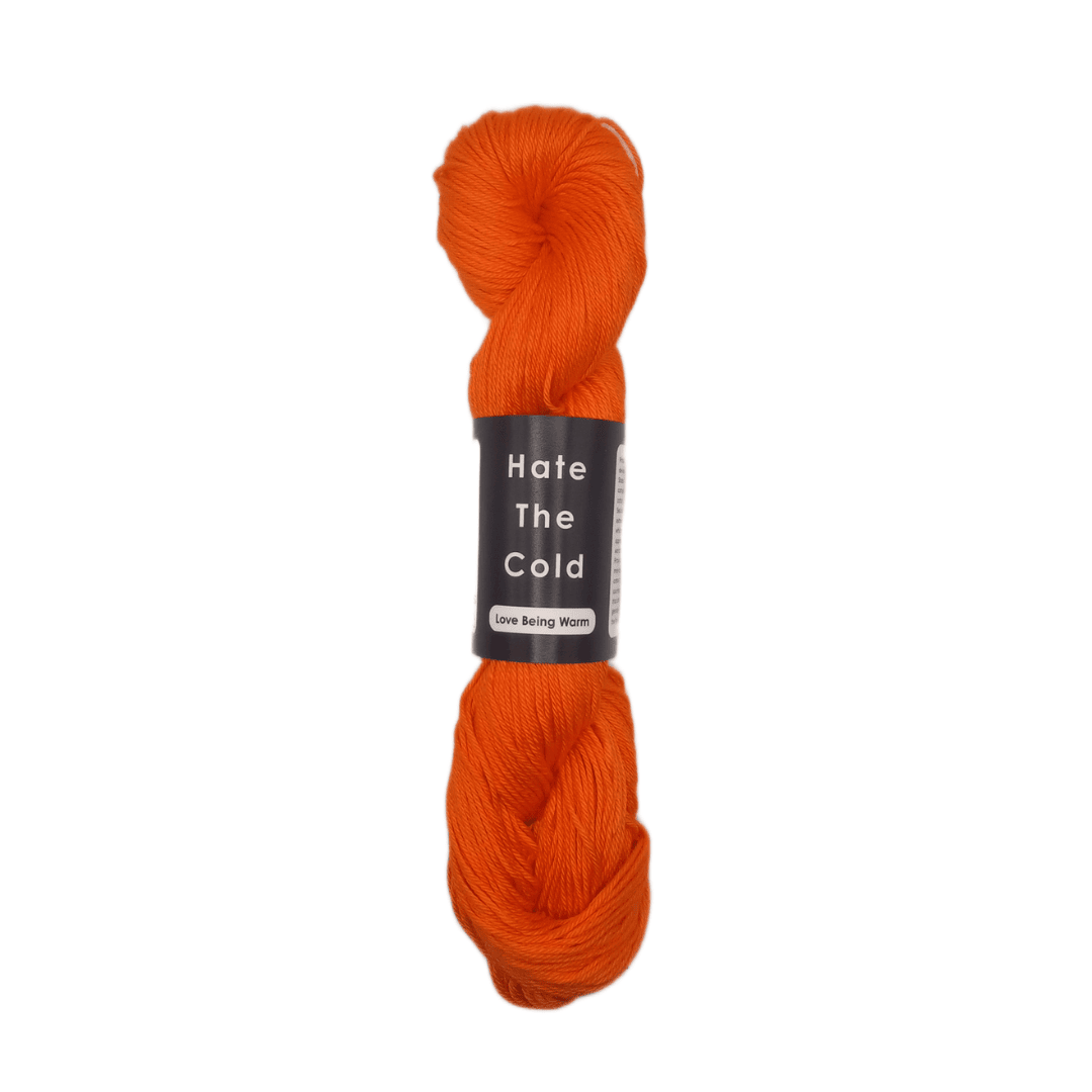 Orange skein of yarn with a label on a white background