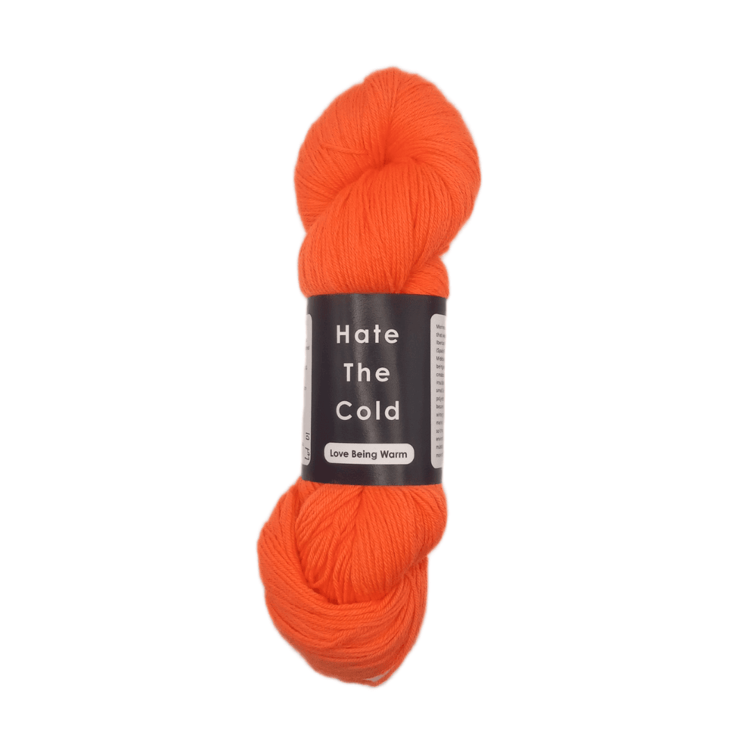 Orange skein of yarn with a label on a white background