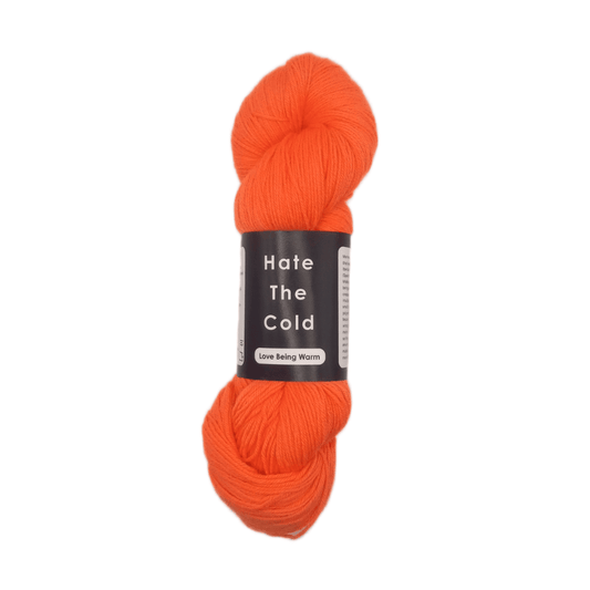 Orange skein of yarn with a label on a white background