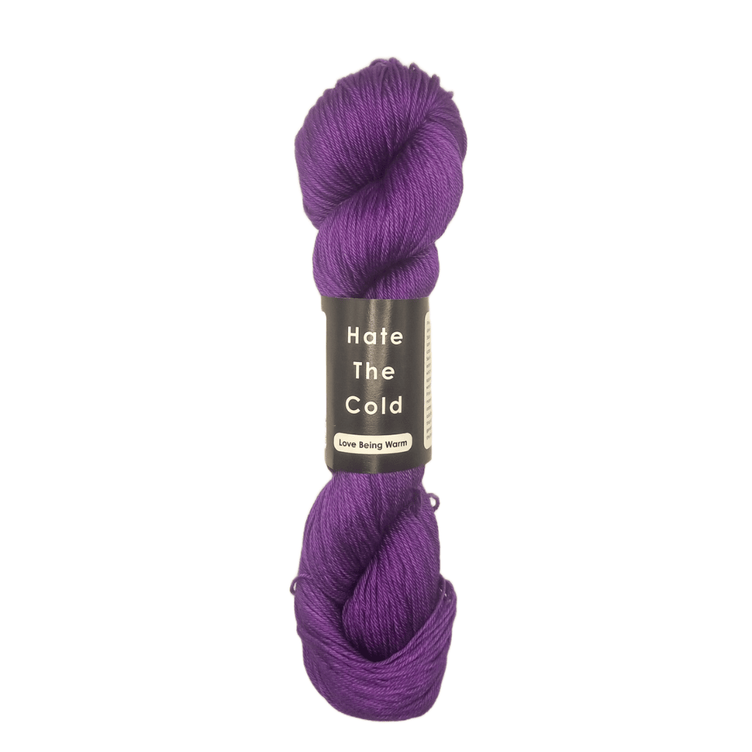 Purple skein of yarn with a label on a white background