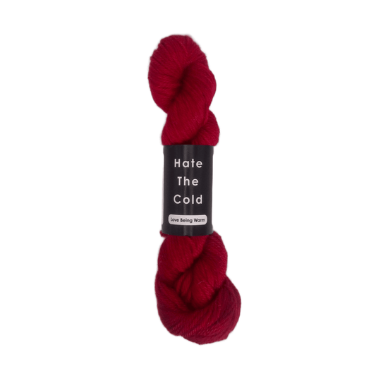 100% Peruvian baby alpaca yarn in red, aran weight.