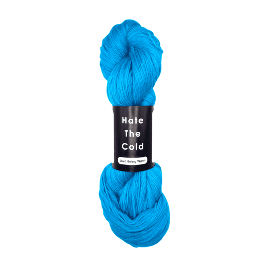 Blue skein of yarn with a label on a white background