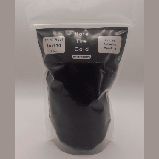 Black wool roving in a package with "Hate The Cold" on the label