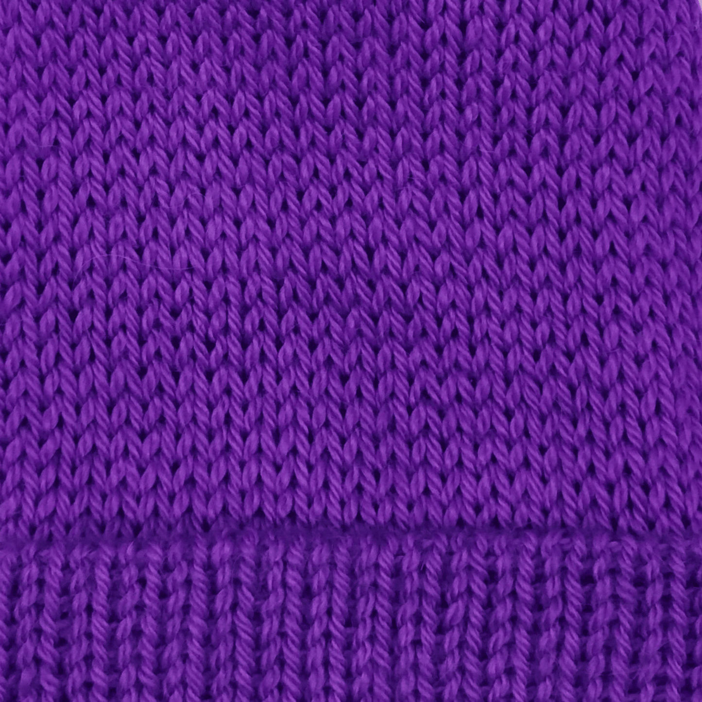 A close-up of a purple knit fabric texture.