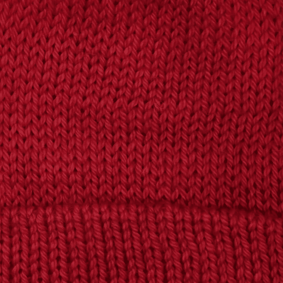 Close-up of worsted weight knit alpaca in red