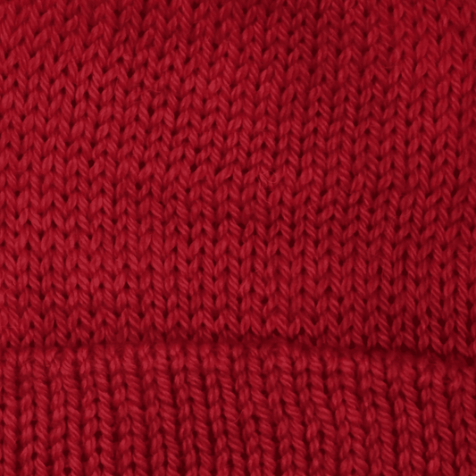 Close-up of worsted weight knit alpaca in red
